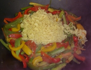 Make a little circle in the middle of the veggies, and add the noodles, then stir to mix