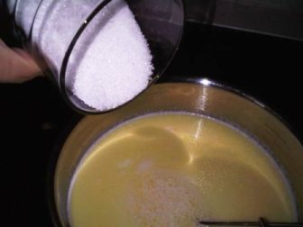 Add a tiny knob of butter, qaimar, and vanilla to the hot milk... stir then add sugar and stir constantly to dissolve every thing together